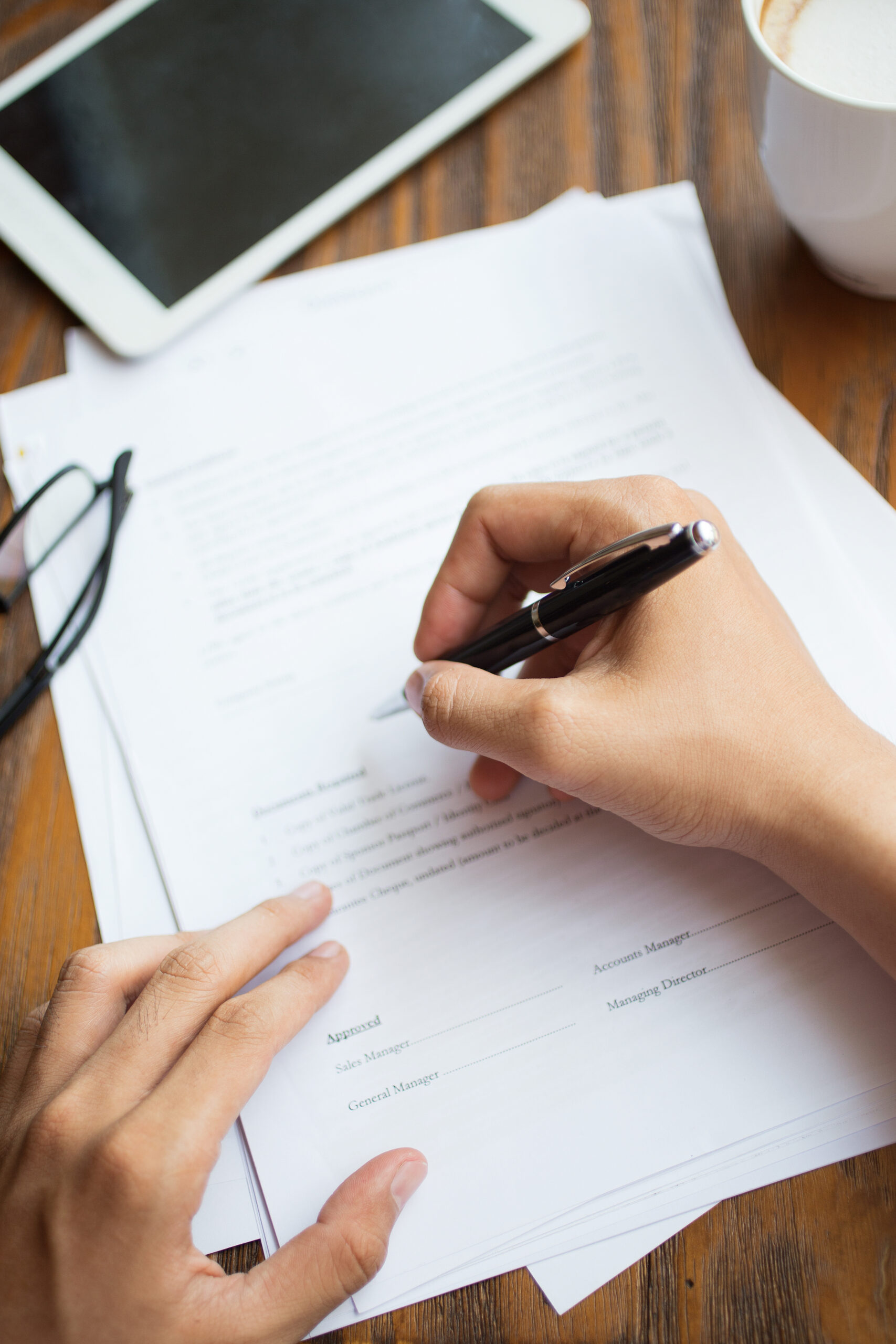 Unrecognizable man filling application form